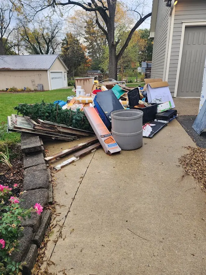 Dumpster being loaded with debris for Roofing Dumpster Rental in Franklin